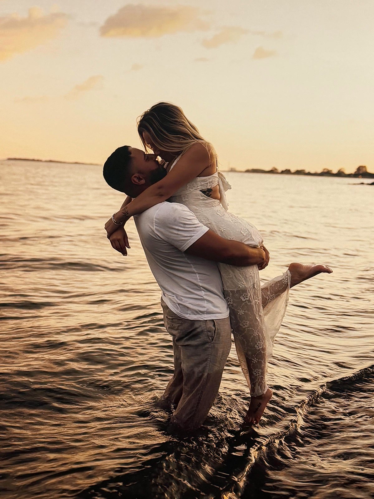 A couple's beach photo printed on a board and displayed on an easel at a party